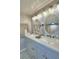 Updated bathroom with double vanity and oval mirrors at 4590 San Heath Rd, Bartow, FL 33830