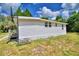 White single-wide manufactured home with a basketball hoop in the yard at 4590 San Heath Rd, Bartow, FL 33830