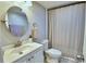 Clean bathroom with a shower/tub combo, white vanity, and a large mirror at 4590 San Heath Rd, Bartow, FL 33830