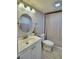 Updated bathroom with a shower/tub, white vanity, and a round mirror at 4590 San Heath Rd, Bartow, FL 33830