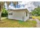 Side view of a white single-story house with green grass at 4590 San Heath Rd, Bartow, FL 33830