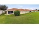 View of home's back and side yards with lush green grass at 142 Morning Glory Cir, Winter Haven, FL 33884