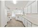 Kitchen with white cabinets, tile flooring, and stainless steel appliances at 142 Morning Glory Cir, Winter Haven, FL 33884