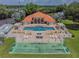 Community pool with surrounding patio and shuffleboard courts at 142 Morning Glory Cir, Winter Haven, FL 33884