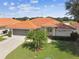One-story house with a terracotta tile roof and lush landscaping at 142 Morning Glory Cir, Winter Haven, FL 33884