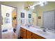 Double vanity bathroom with wood cabinets and a large mirror at 708 Canberra Rd, Winter Haven, FL 33884