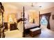 Spacious main bedroom with a large four-poster bed and plenty of natural light at 708 Canberra Rd, Winter Haven, FL 33884