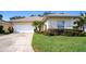Charming single story home with attached garage and manicured landscaping at 708 Canberra Rd, Winter Haven, FL 33884