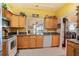 Bright kitchen with wood cabinets, granite countertops, and stainless steel appliances at 708 Canberra Rd, Winter Haven, FL 33884