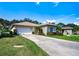 Exterior view of the house with a driveway and landscaping at 708 Canberra Rd, Winter Haven, FL 33884