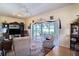 Living room with sliding doors opening to a screened patio and golf course view at 708 Canberra Rd, Winter Haven, FL 33884