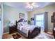 Charming bedroom with a wooden bed frame and large window at 708 Canberra Rd, Winter Haven, FL 33884