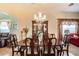 Elegant dining room featuring a large wood table, chandelier, and built-in hutch at 708 Canberra Rd, Winter Haven, FL 33884
