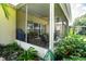 Relaxing screened porch with seating area and lush landscaping at 708 Canberra Rd, Winter Haven, FL 33884