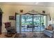 Relaxing living room with rocking chair and view of a screened patio and golf course at 708 Canberra Rd, Winter Haven, FL 33884
