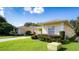 House exterior with landscaping and a spacious yard at 708 Canberra Rd, Winter Haven, FL 33884
