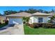 Charming single-story home with a well-manicured lawn at 708 Canberra Rd, Winter Haven, FL 33884