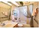 Clean bathroom with shower/tub combo and decorative wallpaper at 708 Canberra Rd, Winter Haven, FL 33884