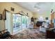 Living room with sliding doors leading to a patio and view of trees at 708 Canberra Rd, Winter Haven, FL 33884