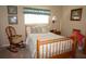 Cozy guest bedroom with full-size bed and rocking chair at 3832 Traditions N Blvd, Winter Haven, FL 33884