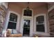 Elegant front entry featuring a charming bench and decorative lighting at 3832 Traditions N Blvd, Winter Haven, FL 33884