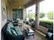 Screened porch with seating and dining area at 3832 Traditions N Blvd, Winter Haven, FL 33884