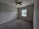 Spacious bedroom with ceiling fan and window at 991 First Dr, Eagle Lake, FL 33839