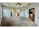 Large main bedroom with carpeted floors and access to bathroom at 991 First Dr, Eagle Lake, FL 33839