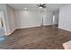 Spacious living room featuring vinyl plank flooring and ceiling fan at 991 First Dr, Eagle Lake, FL 33839