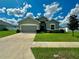 Two story house with gray siding, two-car garage, and manicured lawn at 991 First Dr, Eagle Lake, FL 33839