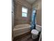 Clean bathroom with tub, toilet and shower at 991 First Dr, Eagle Lake, FL 33839