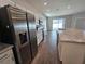 View of kitchen with stainless steel appliances and kitchen island at 991 First Dr, Eagle Lake, FL 33839