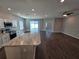Kitchen with island and view into dining area with sliding glass doors at 991 First Dr, Eagle Lake, FL 33839
