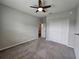 Bright bedroom featuring a double door closet and ceiling fan at 991 First Dr, Eagle Lake, FL 33839