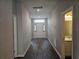 Hallway with dark flooring and access to rooms at 991 First Dr, Eagle Lake, FL 33839