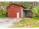 Large red barn with attached carport and separate storage area at 5303 Tillman Rd, Lakeland, FL 33810