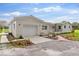 Newly renovated home with white brick exterior, landscaping, and a spacious lawn at 5303 Tillman Rd, Lakeland, FL 33810