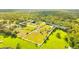 Aerial view of a large property with boundaries outlined, lush green pastures, trees and a home at 5303 Tillman Rd, Lakeland, FL 33810
