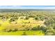 Aerial view of a large property with lush green pastures, trees, and a home at 5303 Tillman Rd, Lakeland, FL 33810