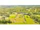 Aerial view of a large property with boundaries outlined, lush green pastures, trees and a home at 5303 Tillman Rd, Lakeland, FL 33810