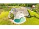 Aerial view showcasing a home, pool, and expansive lot with lush greenery at 5303 Tillman Rd, Lakeland, FL 33810