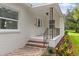 Front entrance with brick steps, black railing, and white brick exterior at 5303 Tillman Rd, Lakeland, FL 33810