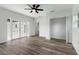 Spacious bedroom with wood-look floors, ceiling fan, French doors and large closet at 5303 Tillman Rd, Lakeland, FL 33810