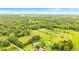 Aerial view of a property with a house, pond and lush green landscape at 5303 Tillman Rd, Lakeland, FL 33810