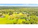 Aerial view of a large property with boundaries outlined, lush green pastures, trees and a home at 5303 Tillman Rd, Lakeland, FL 33810