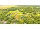 Aerial view of expansive property with multiple buildings and lush greenery at 5303 Tillman Rd, Lakeland, FL 33810