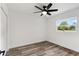 Bright bedroom with wood-look floors and a view of nature at 5303 Tillman Rd, Lakeland, FL 33810