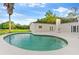 Inviting kidney-shaped pool with expansive patio and outdoor fireplace at 5303 Tillman Rd, Lakeland, FL 33810