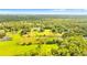 Aerial view of a large property with lush green pastures, trees, and a home at 5303 Tillman Rd, Lakeland, FL 33810