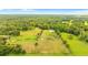 Aerial view of a property with a house and surrounding farmland at 5303 Tillman Rd, Lakeland, FL 33810